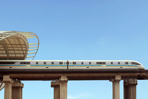 Shanghai Maglev train speeding above on elevated track, viewed from below the bridge