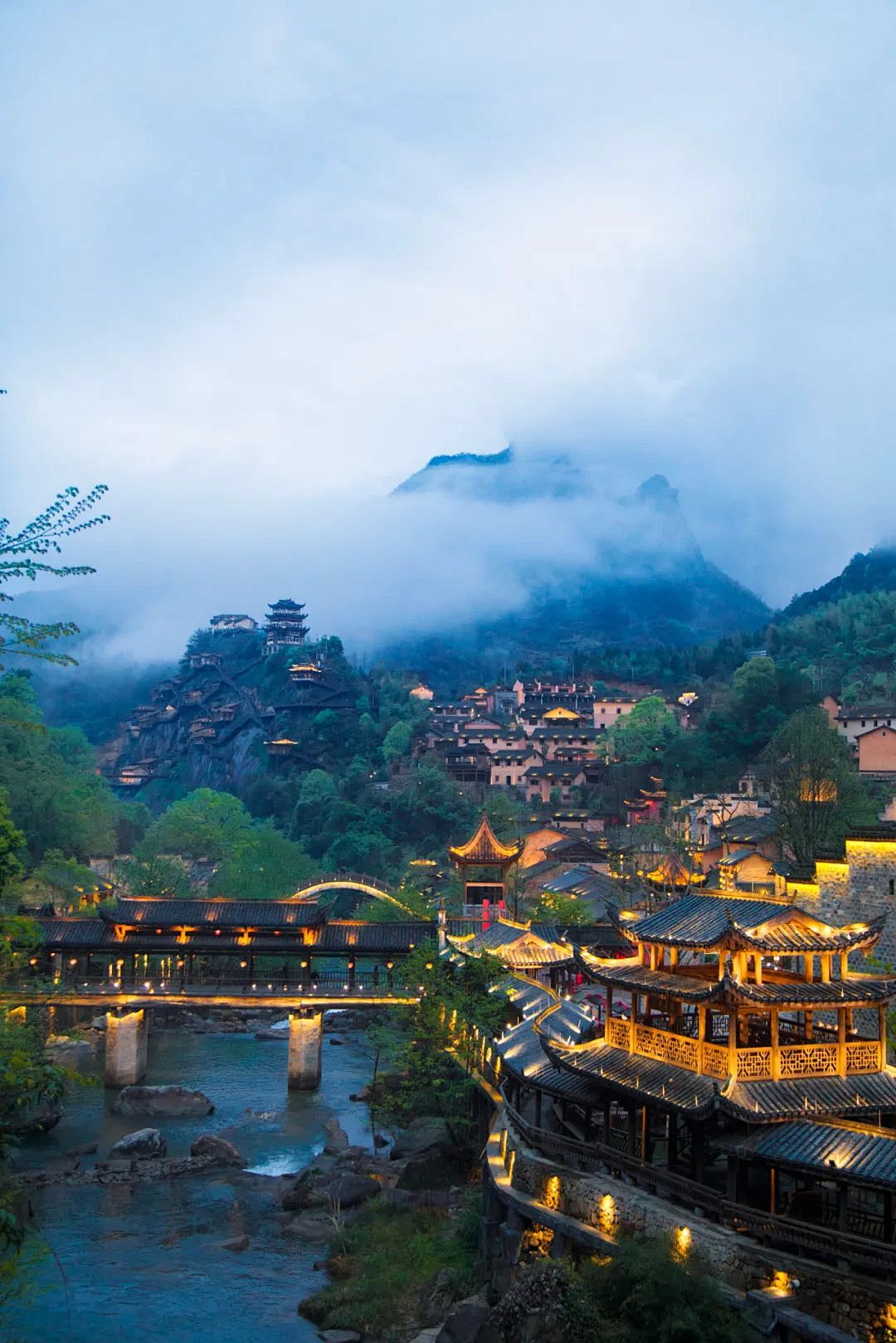 Night view of Wangxiangu Valley with traditional Chinese buildings illuminated along a river, used as a scenic backdrop for China SIM Card with 20GB data and 30-day validity.
