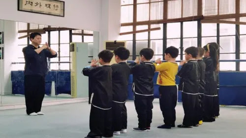 Kung Fu master teaching children basic martial arts moves in Shanghai.