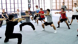 Students practicing the horse stance under the guidance of a Kung Fu master in Shanghai.