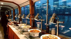 Oriental Pearl Tower glowing at night from Huangpu River cruise