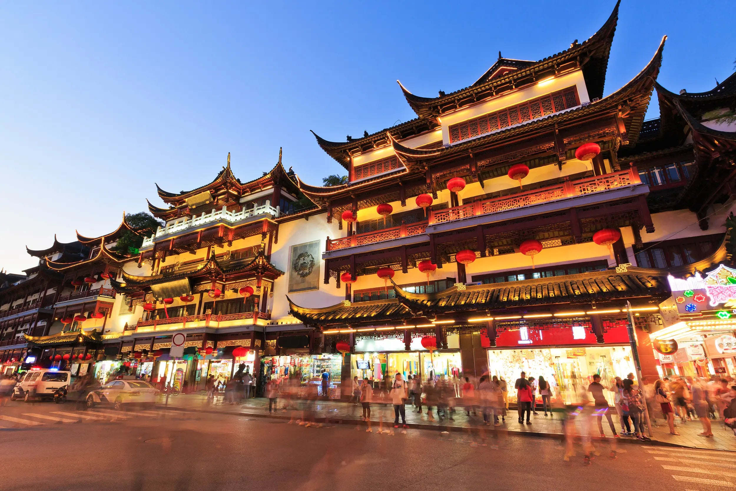 Bustling street scene in Yuyuan Bazaar with traditional shops and crowds