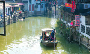 Tourists enjoying a boat ride through Zhujiajiao canals