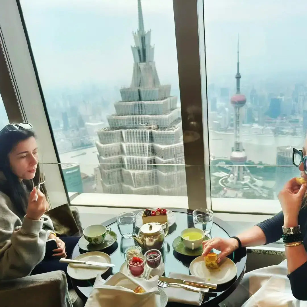 Shanghai First-Time Visitor Day Tour lunch experience with a stunning city view from a skyscraper.