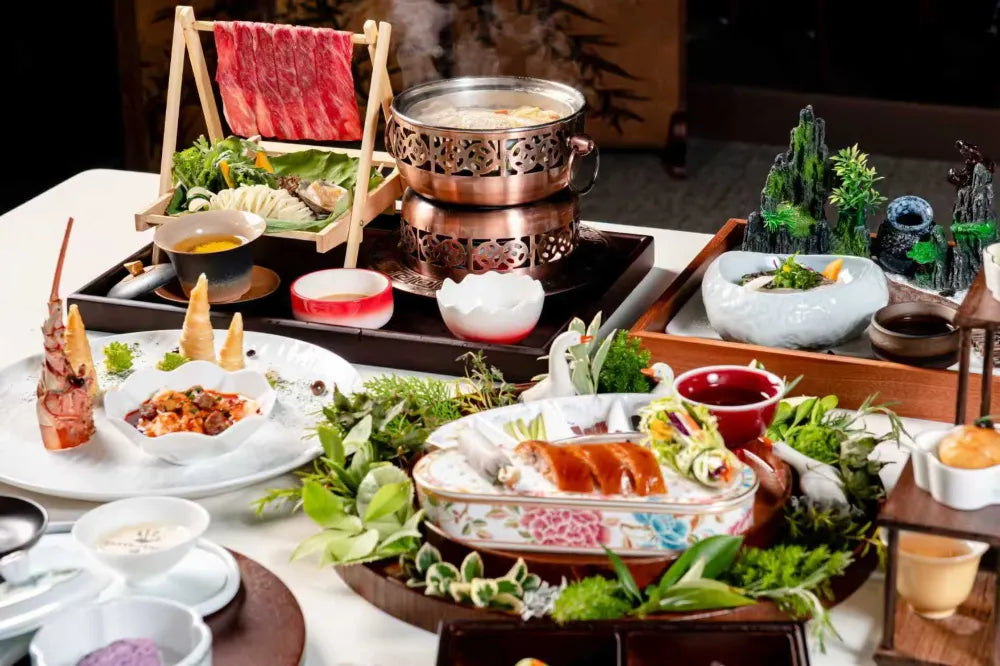 A collection of several Chinese dishes including a hot pot, beautifully arranged for the immersive dining experience at The Bund, Shanghai.