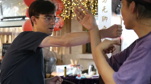 Students practicing Siu Nim Tao form during Wing Chun class