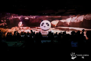 Guests enjoying their meal with a digital panda display in the background at The Bund, Shanghai.