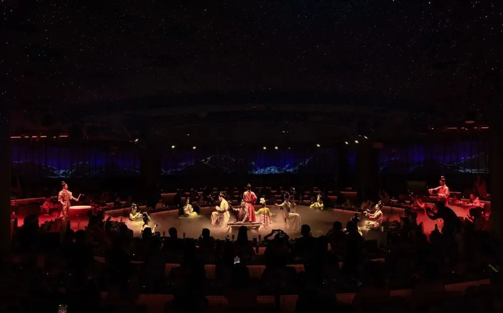 Performers in traditional Hanfu performing at the Shanghai Palace Banquet, with men playing drums and women playing guqin and dancing.