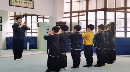 Kung Fu master teaching children basic martial arts moves in Shanghai.