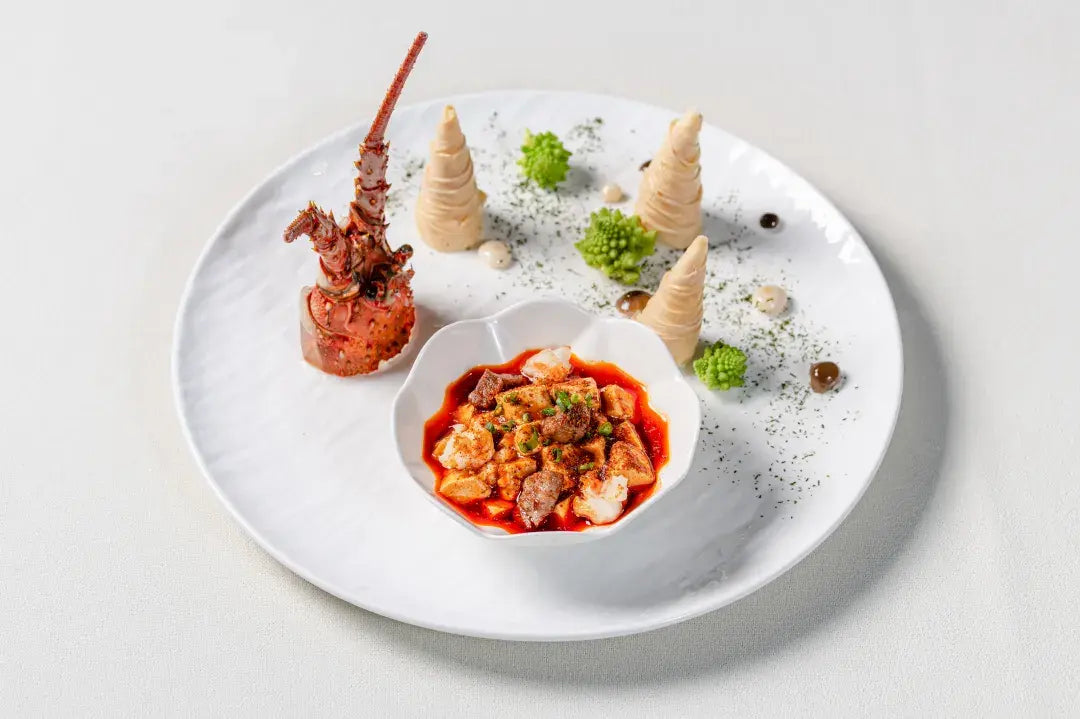 A dish featuring lobster meat and tofu, elegantly plated for the immersive dining experience at The Bund, Shanghai.