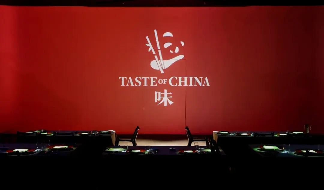 Red wall decorated with bamboo and “TASTEOFCHINA” lettering, highlighting the restaurant’s theme at The Bund, Shanghai.
