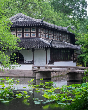 Yuanxiang Hall, the main hall of Humble Administrator's Garden, surrounded by lotus pond and rockeries, offering a serene and elegant waterside view.