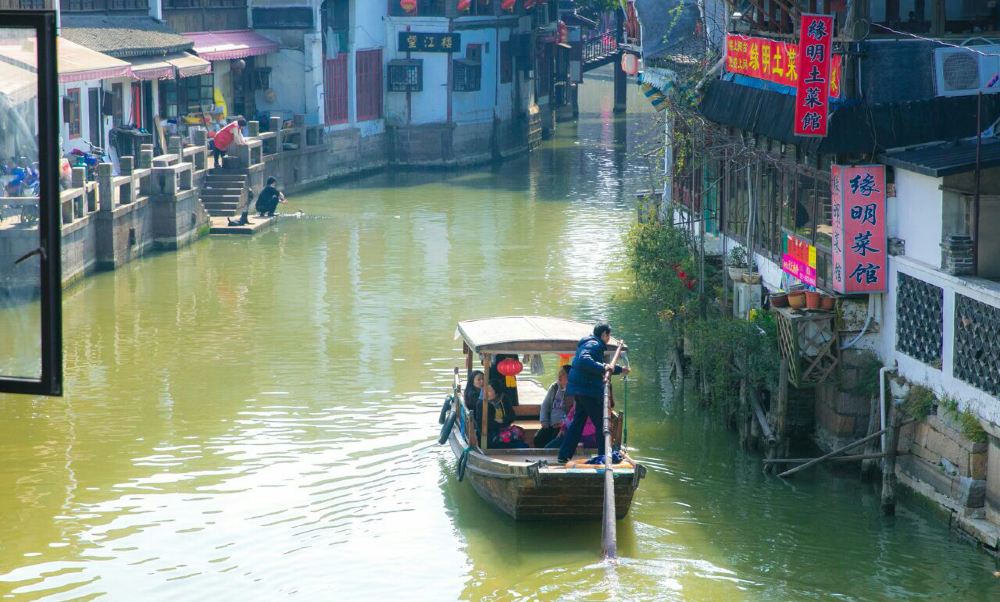 Tourists enjoying a boat ride through Zhujiajiao canals
